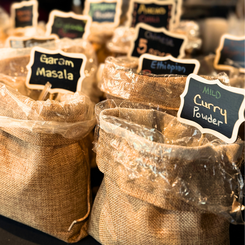 Burlap spice bags labeled Garam Masala and Mild Curry Powder